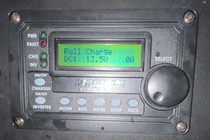 Slide: The Image of Battery monitor display showing full charge at 13.5V on Island Packet 40, 1995 model. - 26