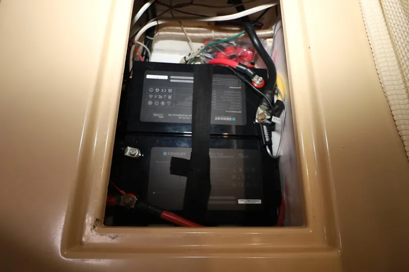 Slide: The Image of Battery compartment of a 1995 Island Packet 40 sailboat with wiring and connections. - 29