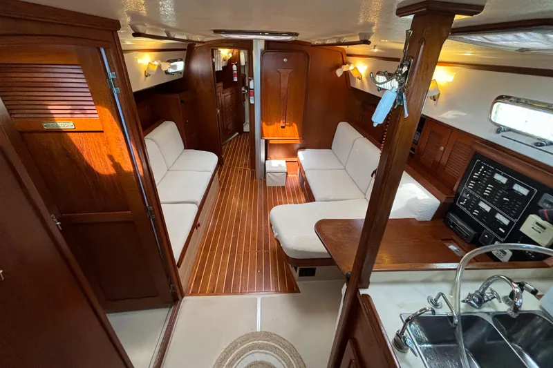 Slide: The Image of Interior of 1995 Island Packet 40 sailboat with wood finish and cozy seating area. - 3