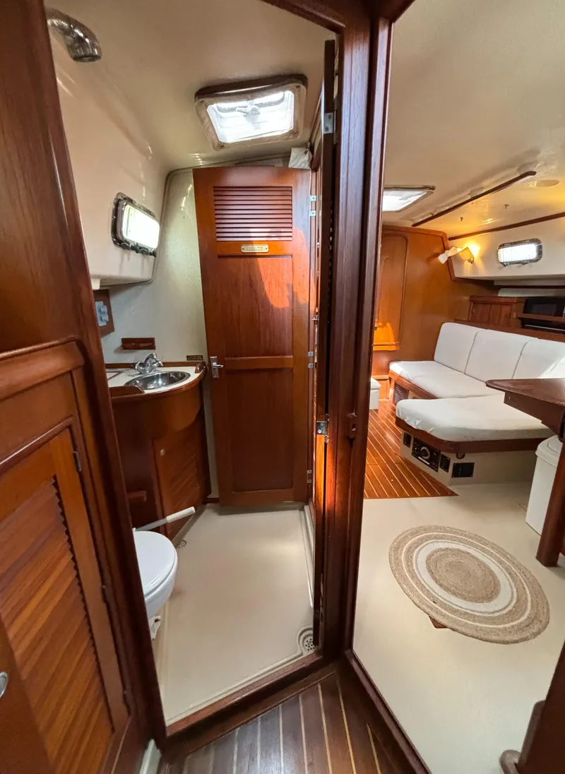 Slide: The Image of Interior of a 1995 Island Packet 40 sailboat, featuring a cozy cabin and wooden finishes. - 31