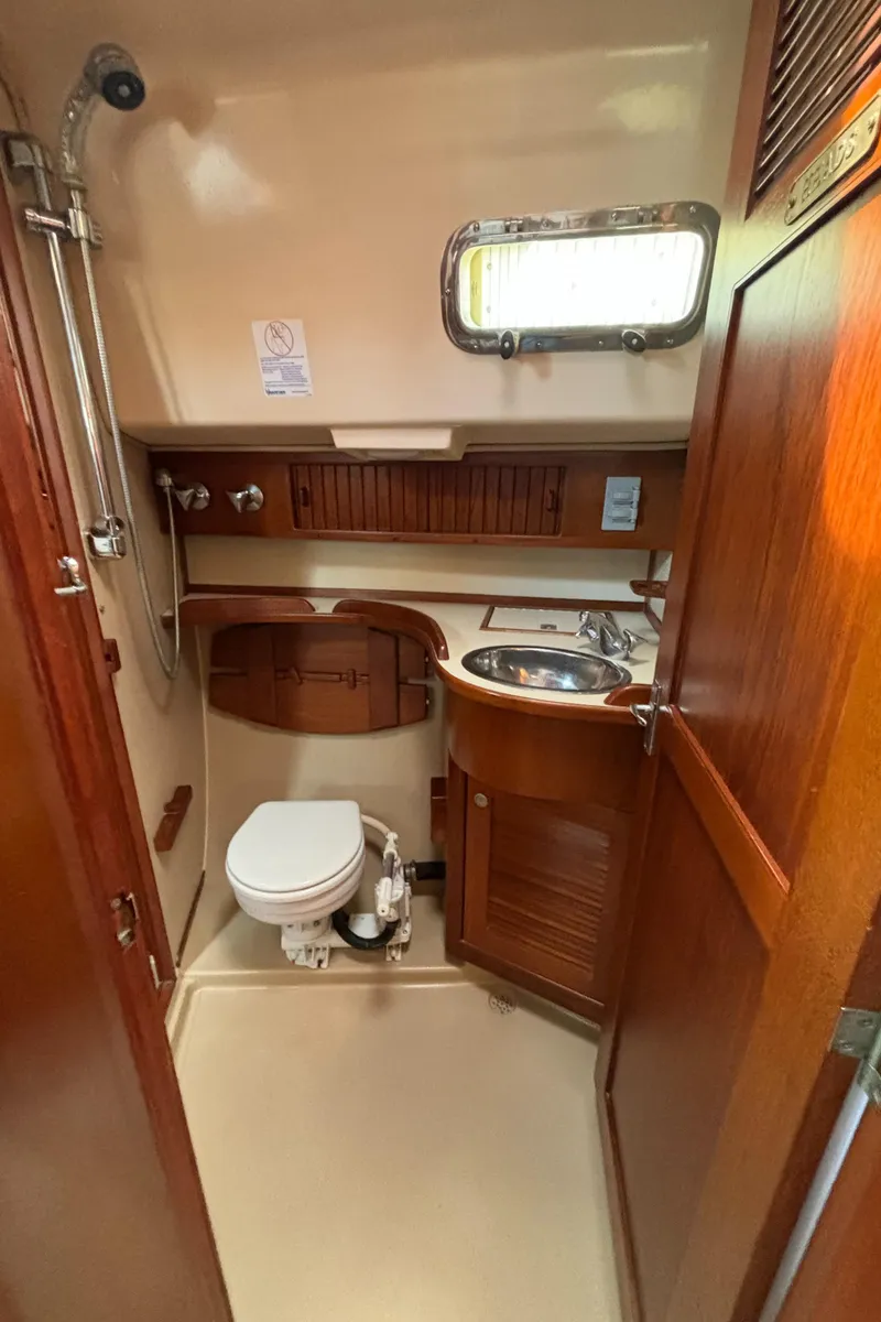 Slide: The Image of 1995 Island Packet 40 yacht bathroom with wooden cabinetry and compact design. - 36