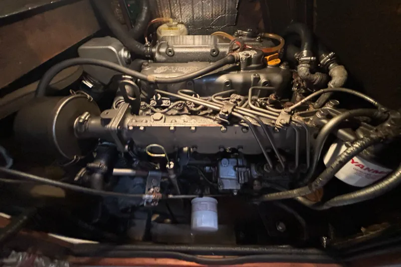 Slide: The Image of Engine compartment of a 1995 Island Packet 40 sailboat, showcasing detailed mechanical components. - 39