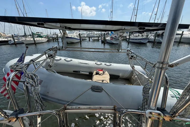 Slide: The Image of Island Packet 40 sailboat stern view with dinghy, docked in marina, 1995 model. - 41