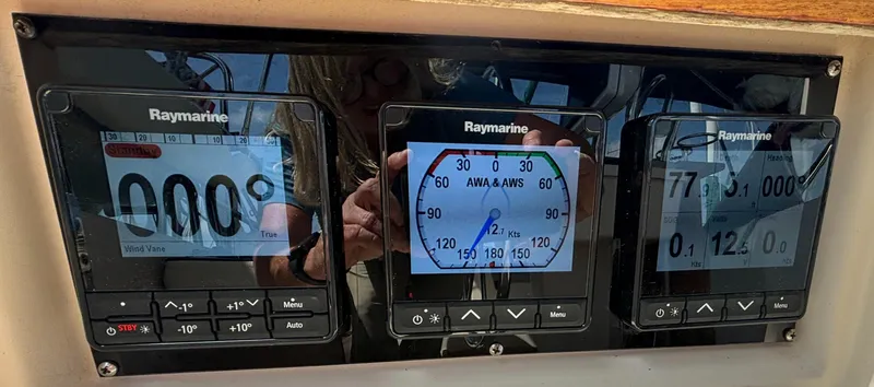 Slide: The Image of Raymarine navigation instruments on a 1995 Island Packet 40 sailboat dashboard. - 43