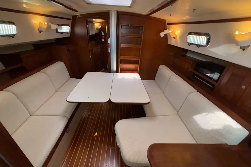 Slide: The Image of Interior of 1995 Island Packet 40 sailboat with cozy seating and wooden finishes. - 5