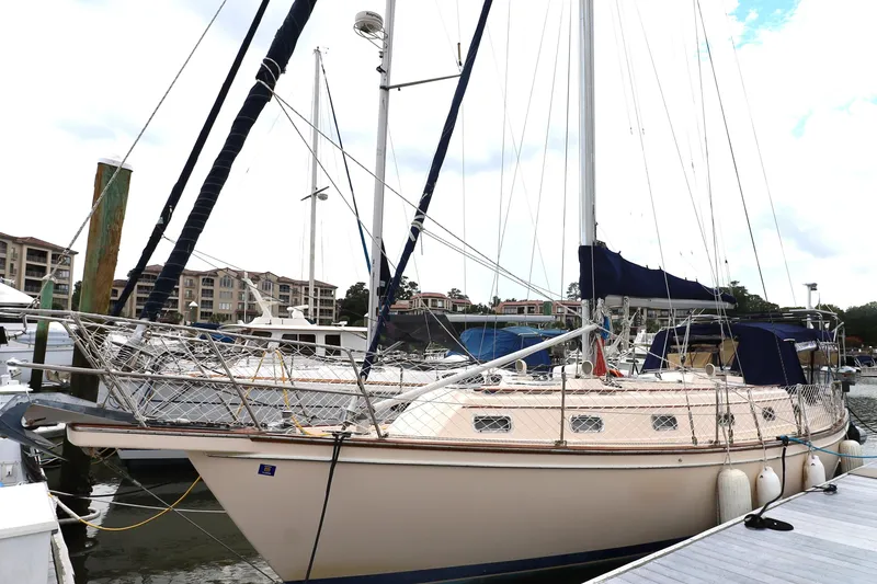 Slide: The Image of Sailboat docked at marina, Island Packet 40, 1995 model, with blue covers. - 61