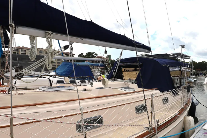 Slide: The Image of Sailboat Island Packet 40, 1995 model, docked at marina with blue canvas covers. - 62