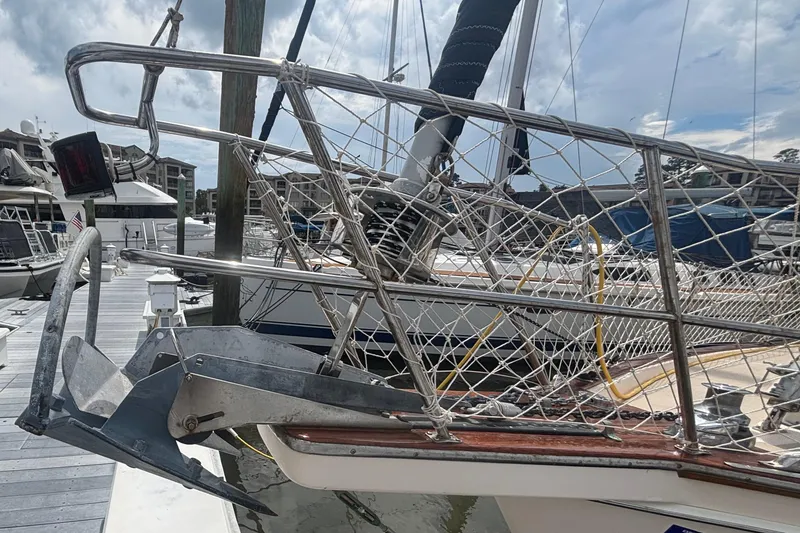 Slide: The Image of 1995 Island Packet 40 sailboat bow with anchor and netting at marina dock. - 66