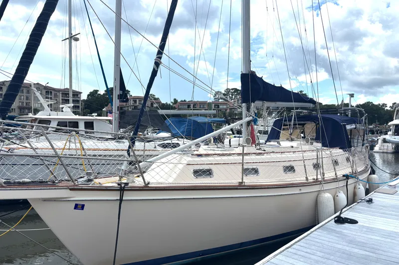 Slide: The Image of 1995 Island Packet 40 sailboat docked at marina under cloudy sky. - 72