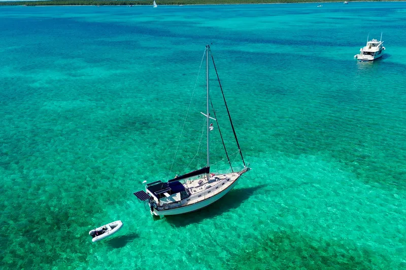 Slide: The Image of Island Packet 40 sailboat anchored in clear turquoise waters, 1995 model. - 75