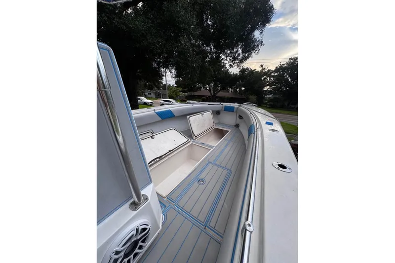 Slide: The Image of 2005 Contender 31 Open boat interior with storage compartments and sleek design. - 4