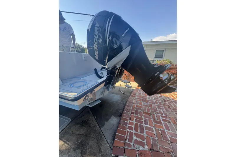 Slide: The Image of 2005 Contender 31 Open boat with Mercury Verado outboard engine, parked on brick driveway. - 6