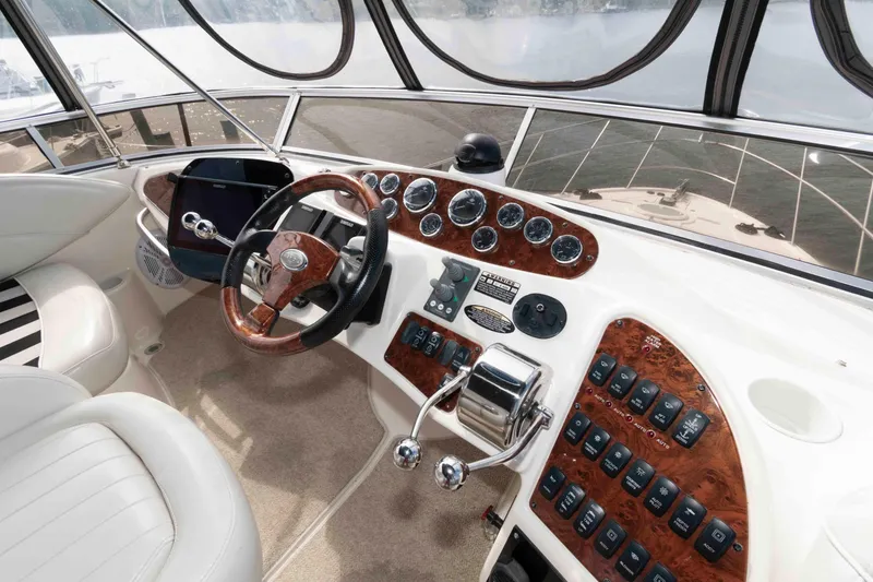 Slide: The Image of 2007 Meridian 459 Motoryacht helm with wood accents and modern controls. - 10