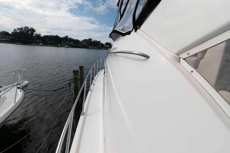 Slide: The Image of 2007 Meridian 459 Motoryacht docked by a serene waterfront. - 11