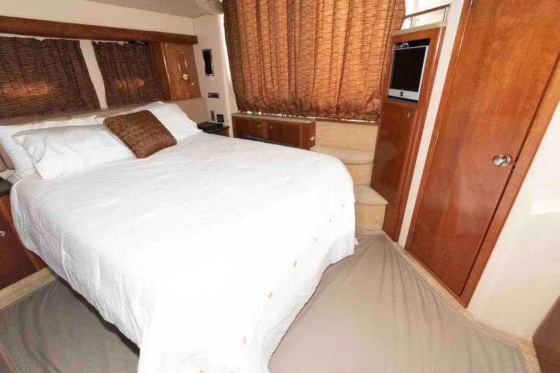Slide: The Image of Luxurious bedroom interior of 2007 Meridian 459 Motoryacht with cozy bed and wooden accents. - 17