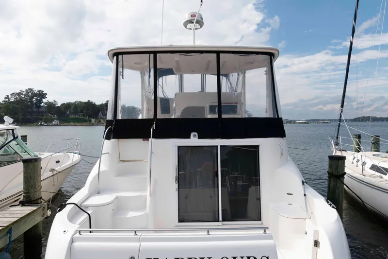Slide: The Image of 2007 Meridian 459 Motoryacht docked, featuring spacious deck and clear skies. - 2