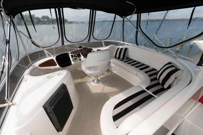 Slide: The Image of Luxurious 2007 Meridian 459 Motoryacht interior with striped seating and panoramic views. - 6