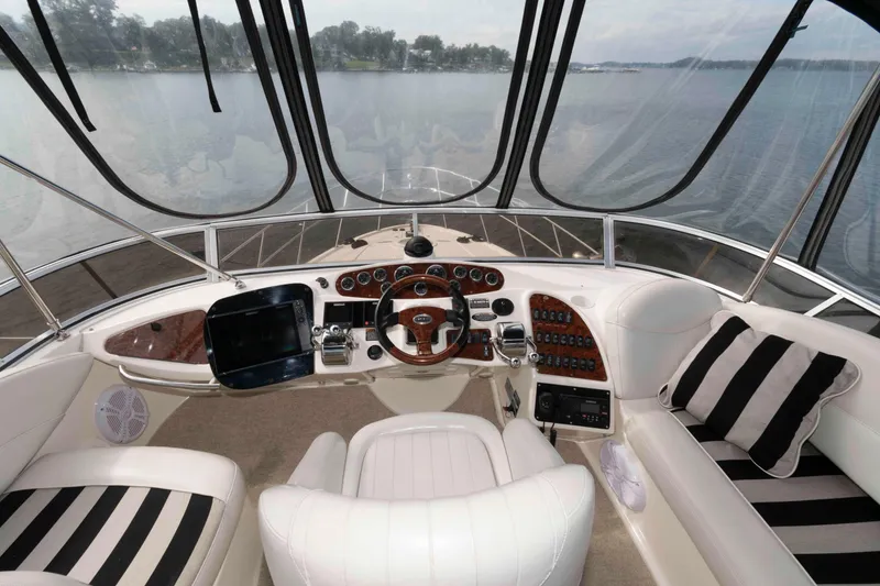 Slide: The Image of Luxurious 2007 Meridian 459 Motoryacht helm with panoramic water view and plush seating. - 7