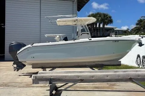 The Image of 2018 Century 2600 Center Console boat on trailer, parked outdoors near a building. - 1