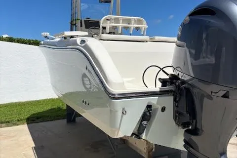 Slide: The Image of 2018 Century 2600 Center Console boat with outboard motor, docked outdoors. - 24
