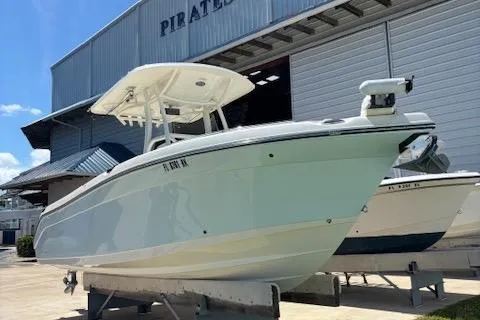 Slide: The Image of 2018 Century 2600 Center Console boat displayed at a marina. - 3