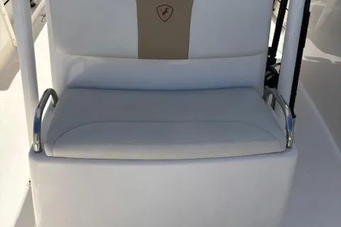 Slide: The Image of Century 2600 Center Console 2018 boat seat with white upholstery and armrests. - 31