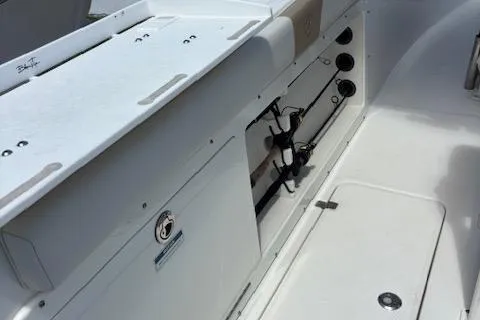 Slide: The Image of 2018 Century 2600 Center Console boat interior with rod holders and storage compartments. - 42