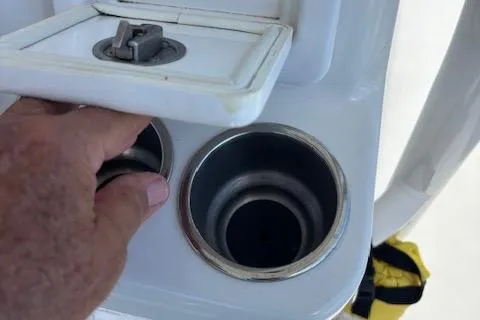 Slide: The Image of Hand accessing cup holders on 2018 Century 2600 Center Console boat. - 8