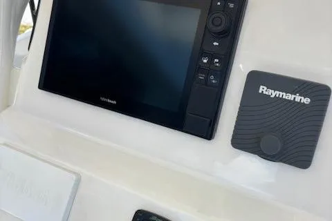 Slide: The Image of Century 2600 Center Console 2018 boat dashboard with Raymarine navigation system. - 9
