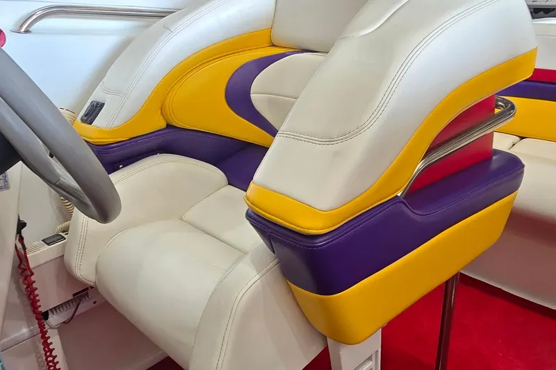 Slide: The Image of 1997 Baja 322 boat interior with vibrant yellow, purple, and white seating. - 11