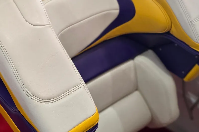 Slide: The Image of White, purple, and yellow boat seat from a 1997 Baja 322. - 12