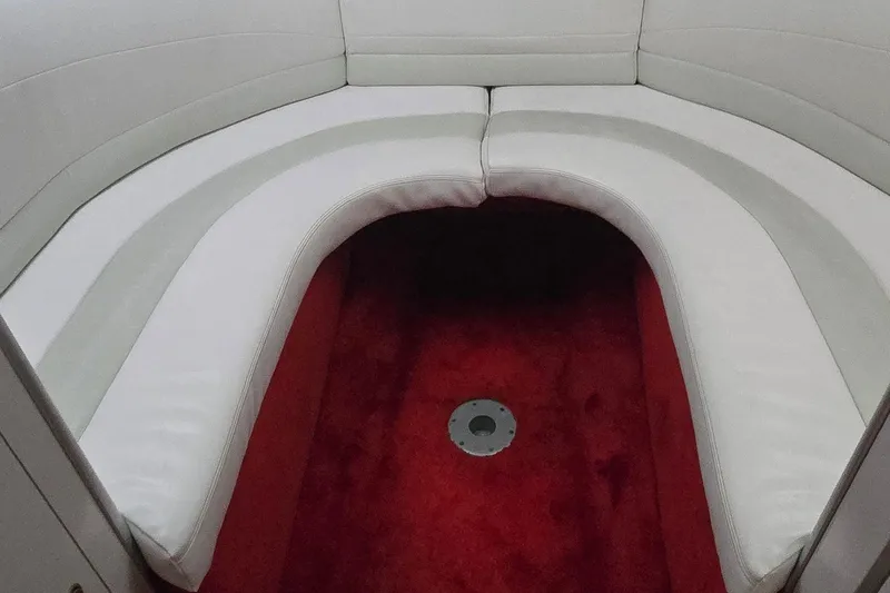 Slide: The Image of 1997 Baja 322 boat interior with white seating and red carpet flooring. - 17