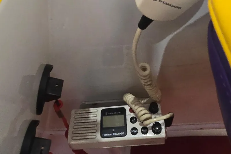 Slide: The Image of VHF radio equipment inside a 1997 Baja 322 boat, featuring a Standard Horizon Eclipse model. - 20