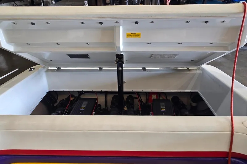 Slide: The Image of Open engine compartment of a 1997 Baja 322 boat, showcasing dual engines. - 22