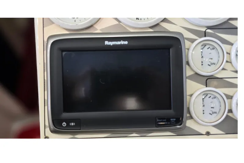 Slide: The Image of 1997 Baja 322 dashboard with Raymarine display and control gauges. - 26