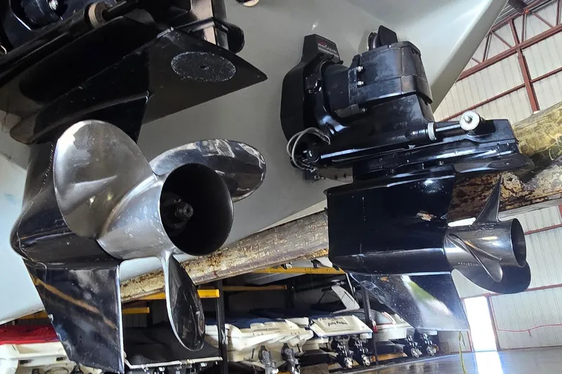 Slide: The Image of 1997 Baja 322 boat propellers and outboard motors in a storage facility. - 27