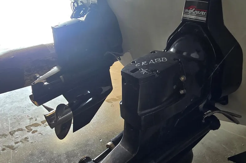 Slide: The Image of 1997 Baja 322 boat engine with MerCruiser outdrive, featuring propeller and "CRABB" marking. - 28