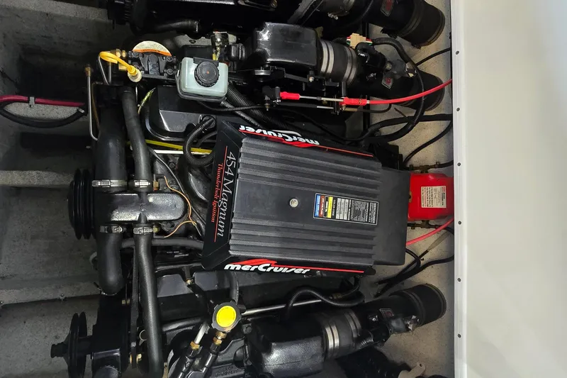 Slide: The Image of Engine compartment of a 1997 Baja 322 boat featuring a MerCruiser 454 Magnum engine. - 30