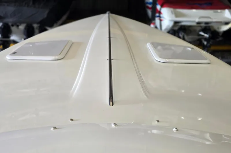 Slide: The Image of Close-up of a 1997 Baja 322 boat deck, showcasing sleek design and hatches. - 4