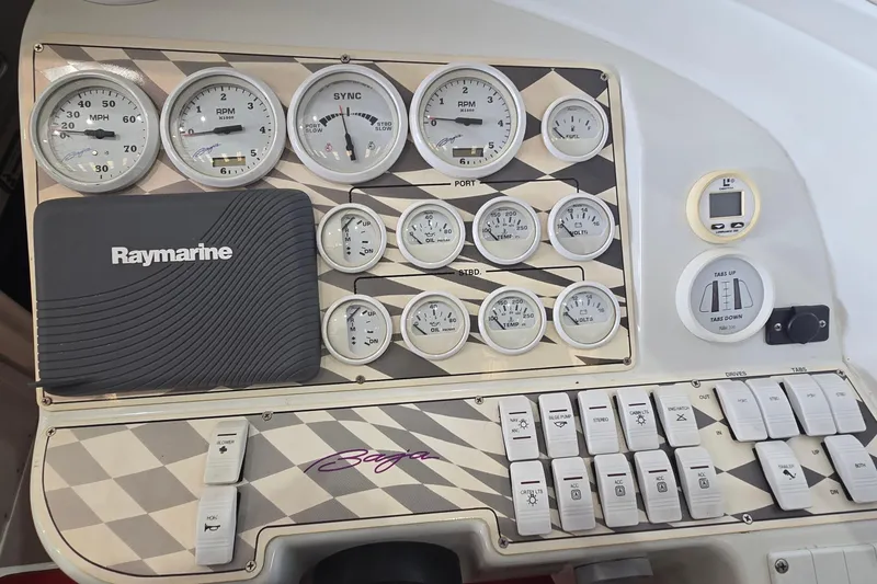 Slide: The Image of Control panel of a 1997 Baja 322 boat with gauges and Raymarine device. - 9