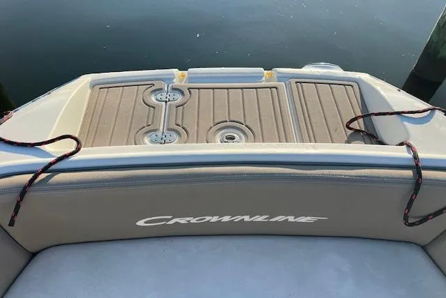 Slide: The Image of 2018 Crownline Eclipse E23 XS boat interior with cushioned seating and speakers. - 13