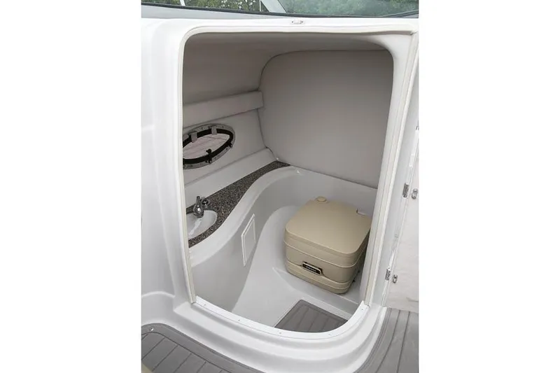 Slide: The Image of 2018 Crownline Eclipse E23 XS boat interior with beige seating and open windshield. - 14