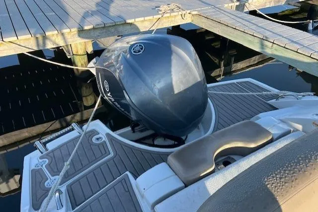 Slide: The Image of 2018 Crownline Eclipse E23 XS boat interior with cushioned seating and speakers. - 16