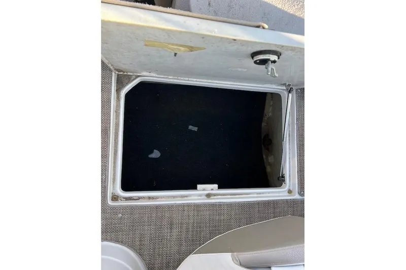 Slide: The Image of 2018 Crownline Eclipse E23 XS boat deck with logo, docked on calm water. - 17