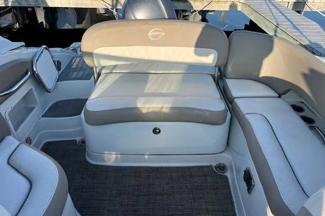 Slide: The Image of 2018 Crownline Eclipse E23 XS boat interior with beige seating and carpeted flooring. - 9