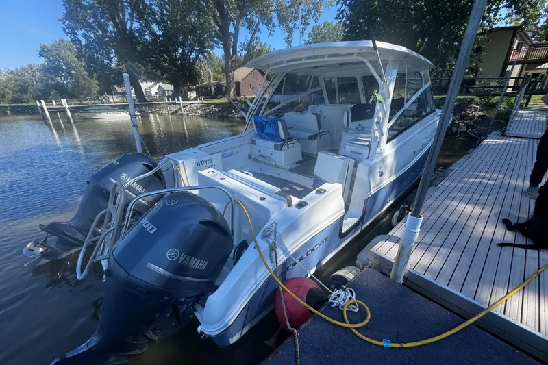 Slide: The Image of 2021 World Cat 320 DC boat docked with dual Yamaha engines. - 15
