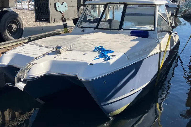 Slide: The Image of 2021 World Cat 320 DC boat docked, featuring sleek design and blue hull. - 38