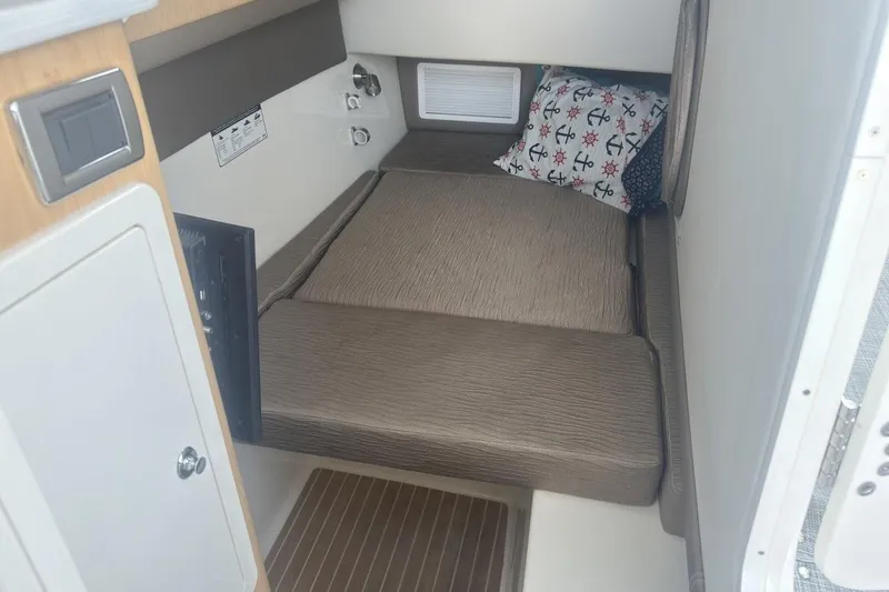 Slide: The Image of 2021 World Cat 320 DC cabin interior with cozy bed and nautical-themed pillow. - 26