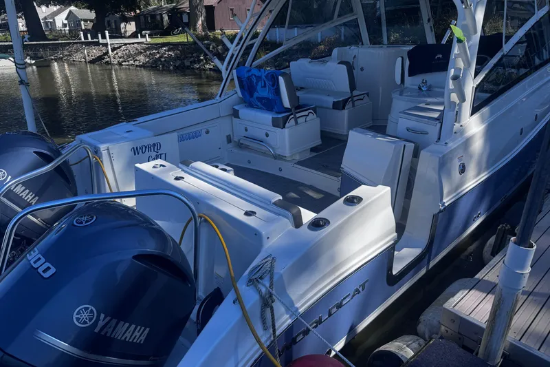 Slide: The Image of 2021 World Cat 320 DC boat docked with Yamaha engines, featuring spacious seating. - 17