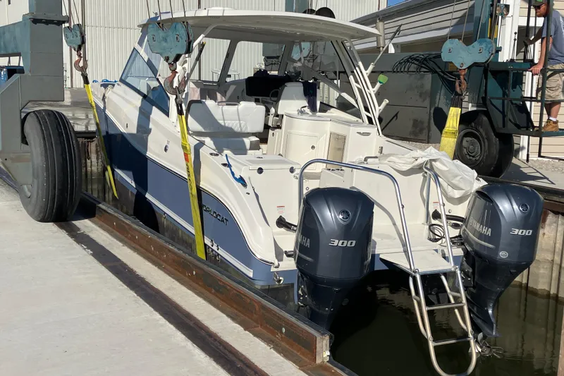 Slide: The Image of 2021 World Cat 320 DC boat with dual Yamaha 300 engines in a dock lift. - 37